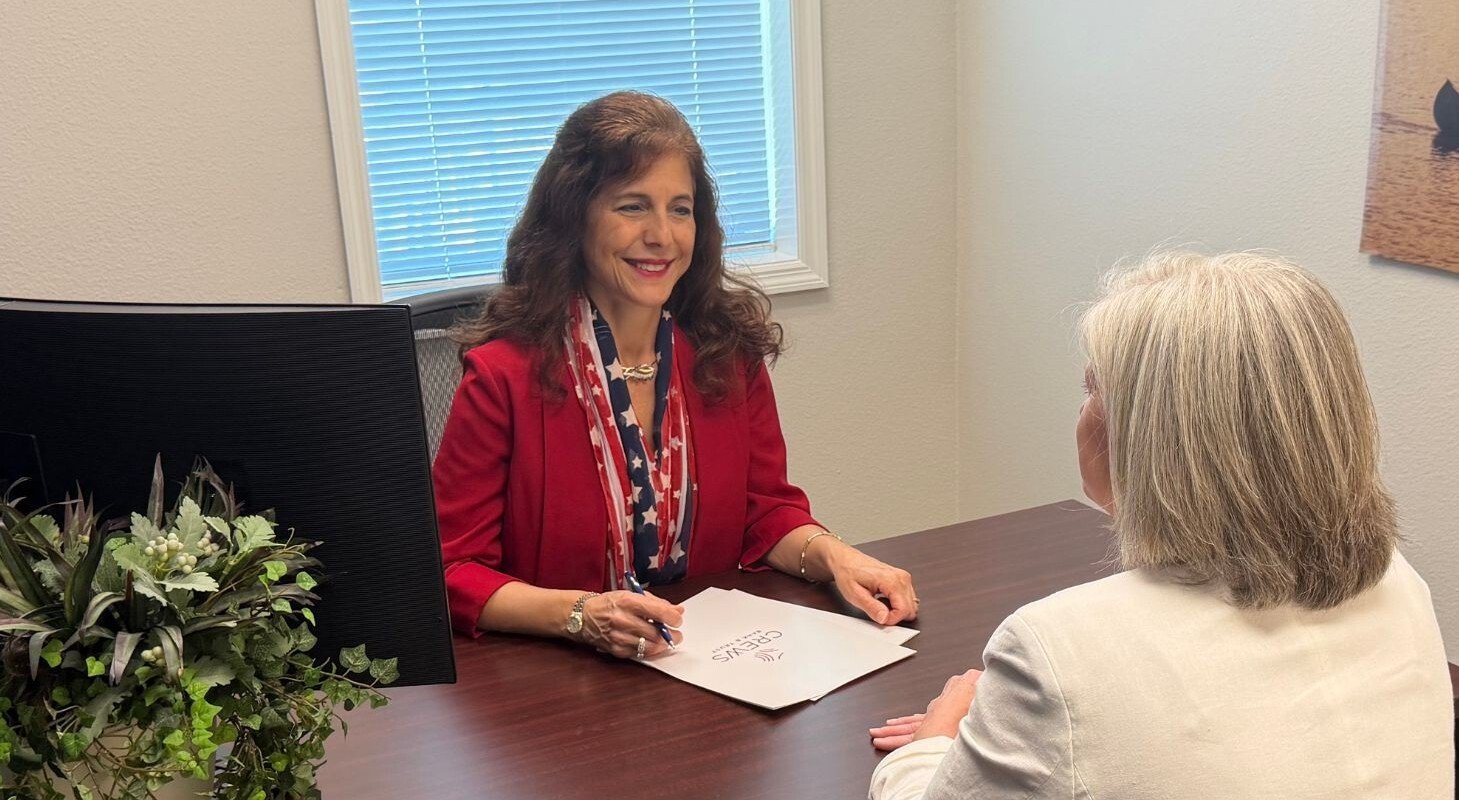 Christine reviewing documents at desk