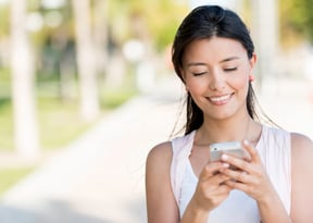 Portrait of a woman making a transfer from her phone