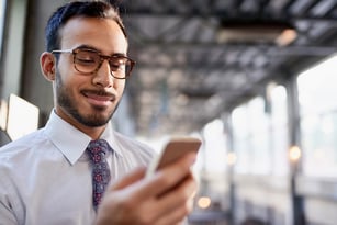 man using mobile phone to enroll in online statements
