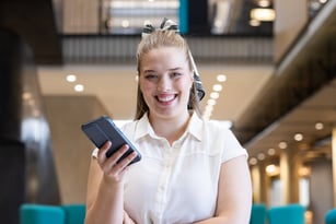 holding-smartphone-smiling-businesswoman-standing-2024-09-24-21-20-29-utc
