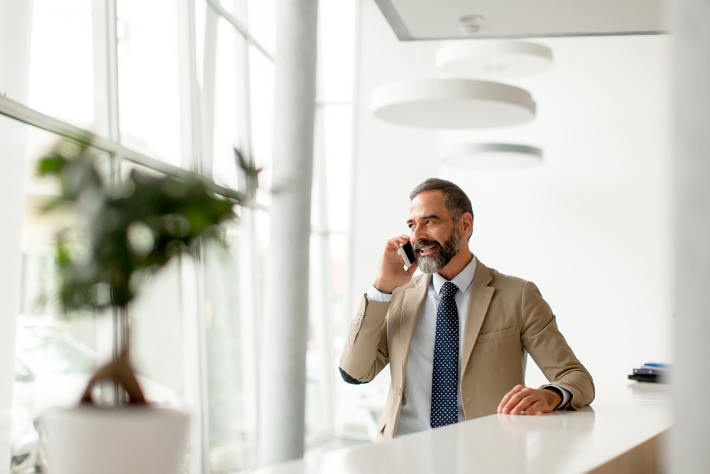 middle-aged-businessman-using-mobile-phone-2022-04-04-23-23-13-utc-1