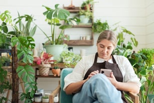 small-business-owner-using-mobile-phone-2023-11-27-05-22-22-utc-1