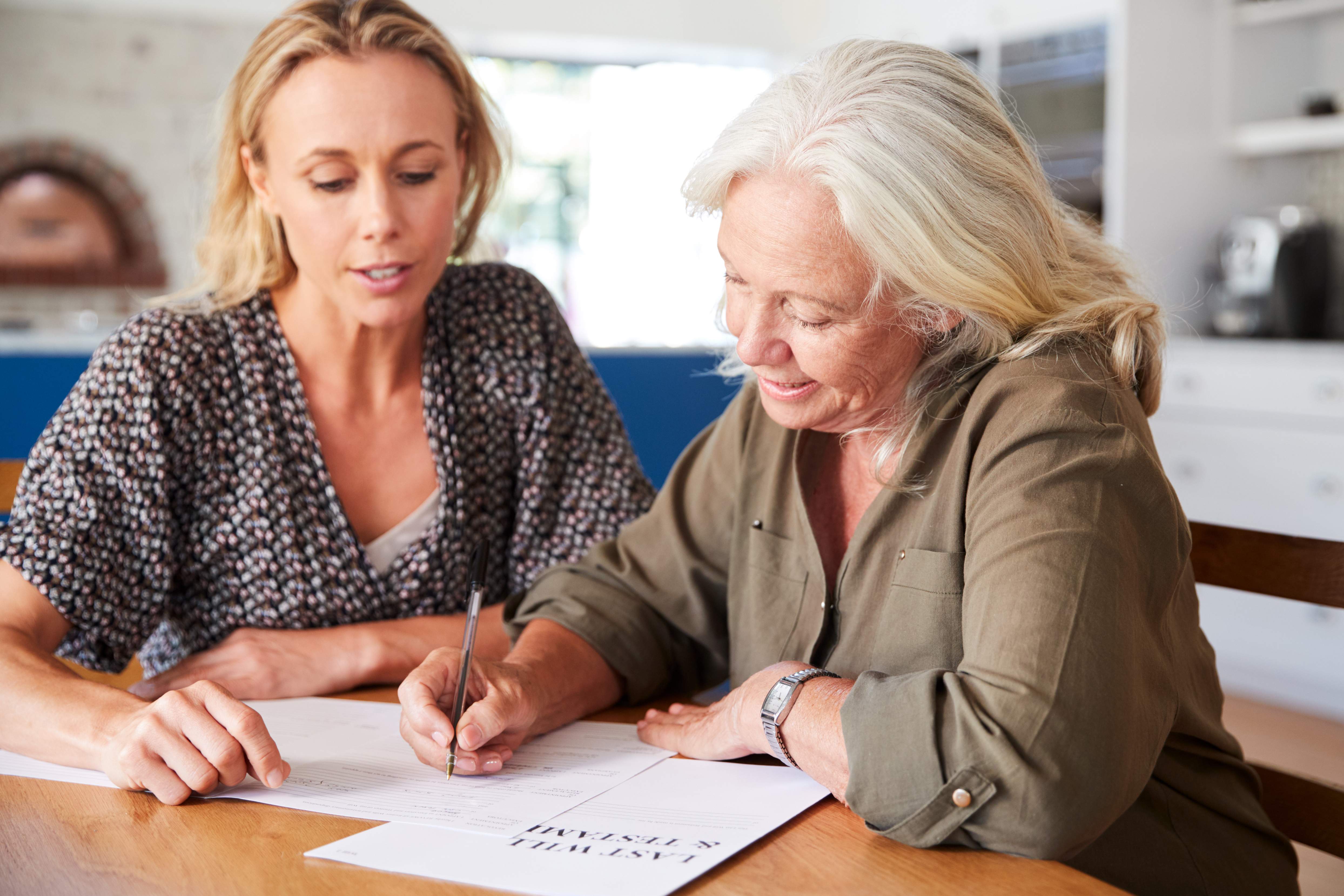 Two women looking at paperwork 