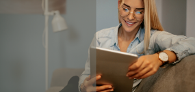 Woman smiling at a tablet