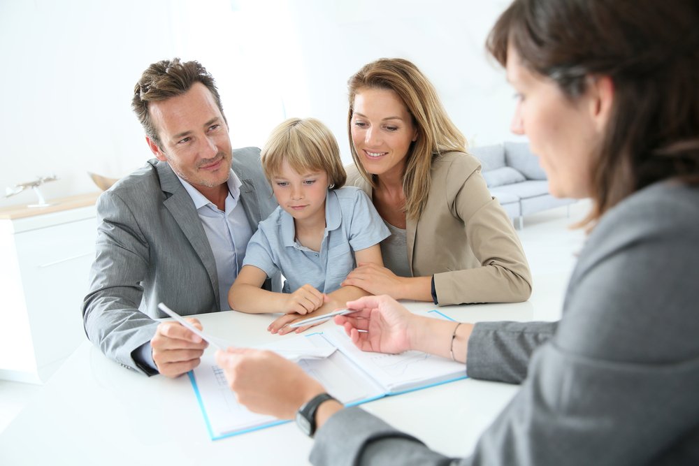 Family looking at paperwork with a trusted advisor 