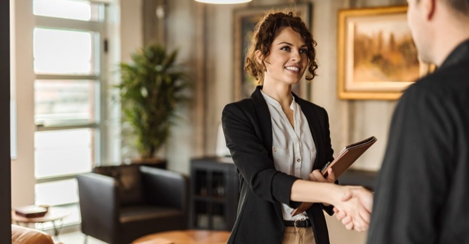 Woman shaking hands with someone off screen