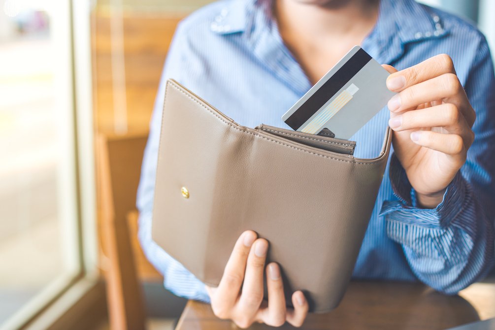 Woman putting a card in her wallet