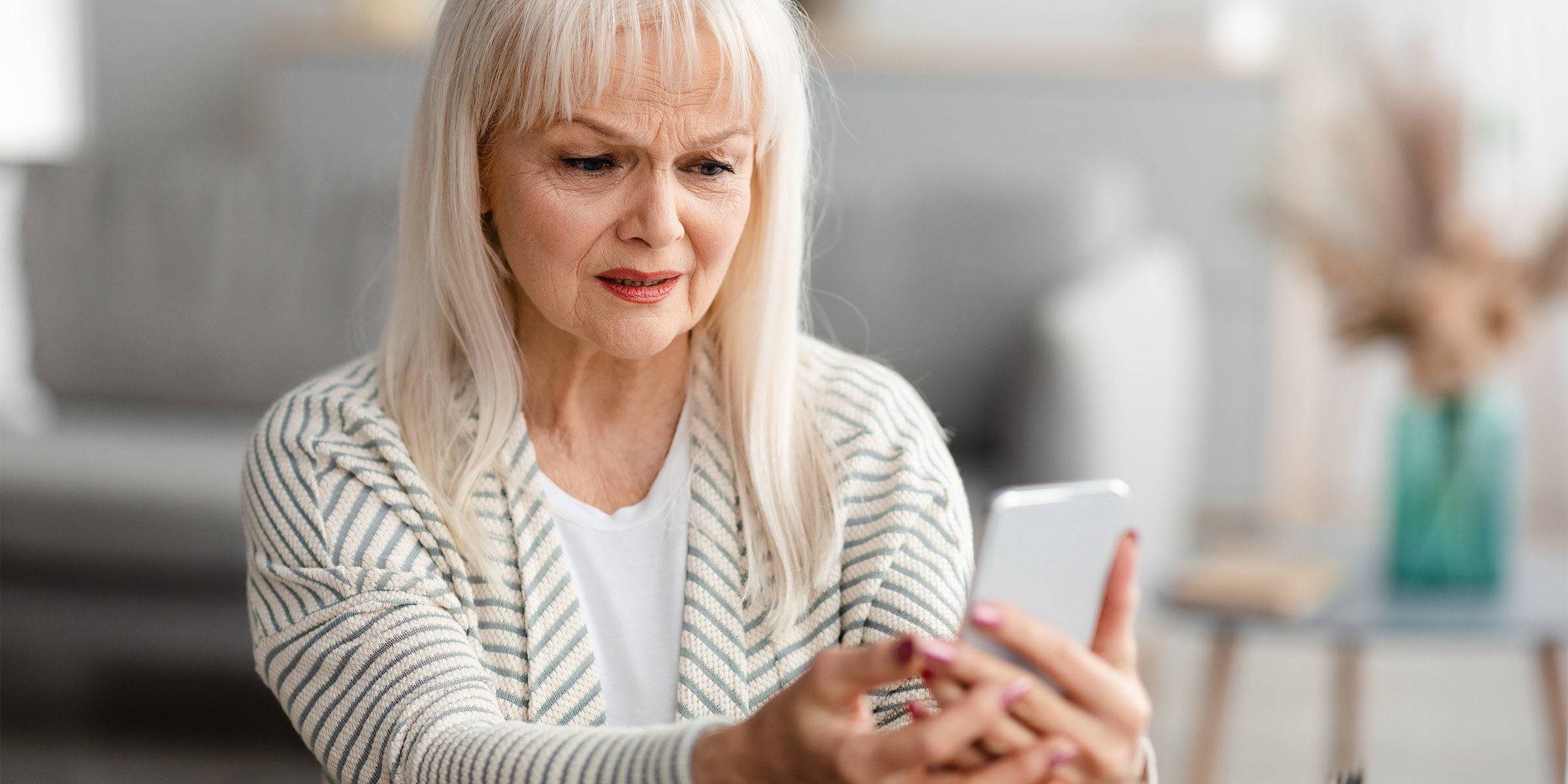 Older woman looking concerned at her phone