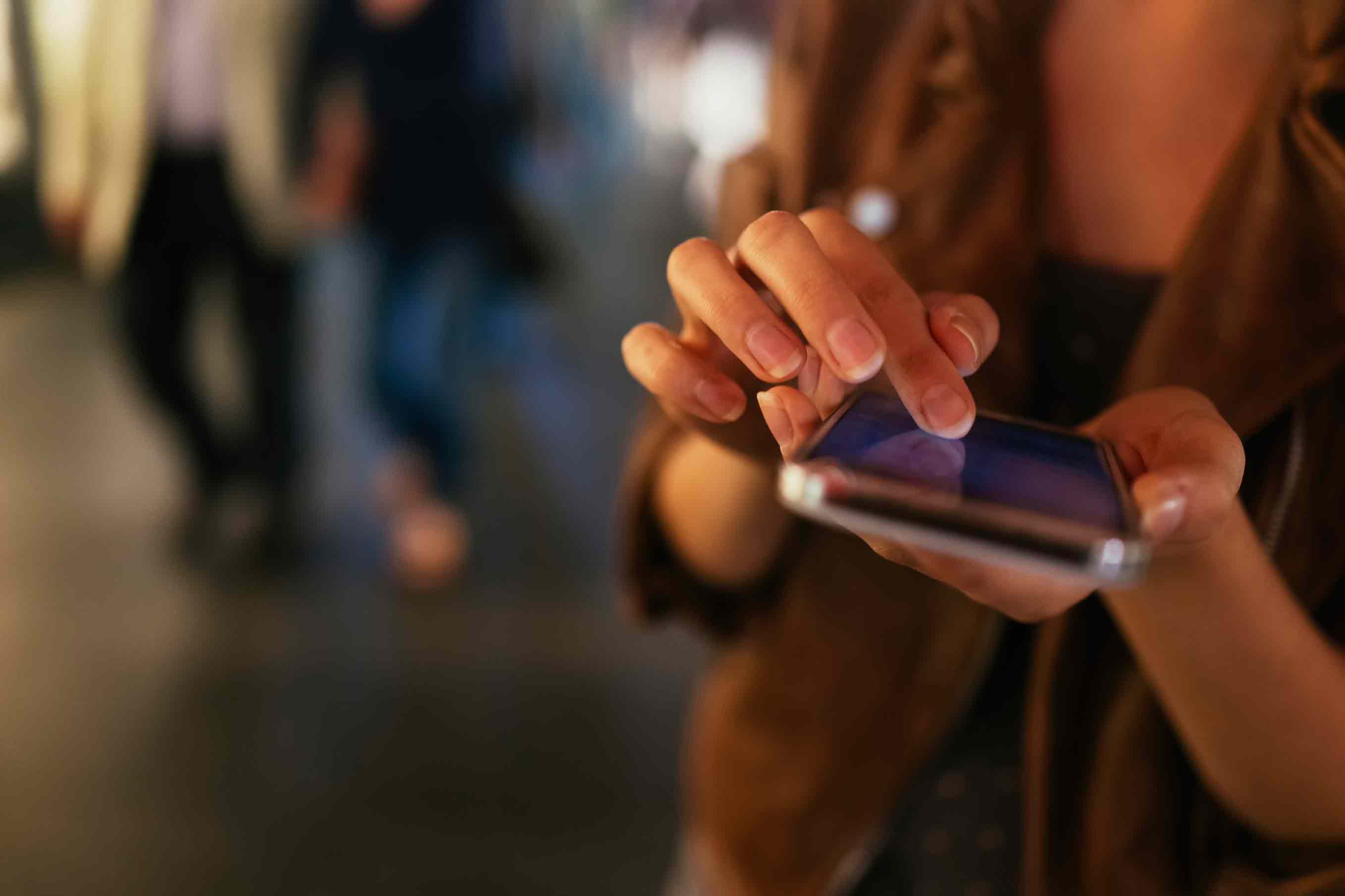 person typing on phone, no face shown