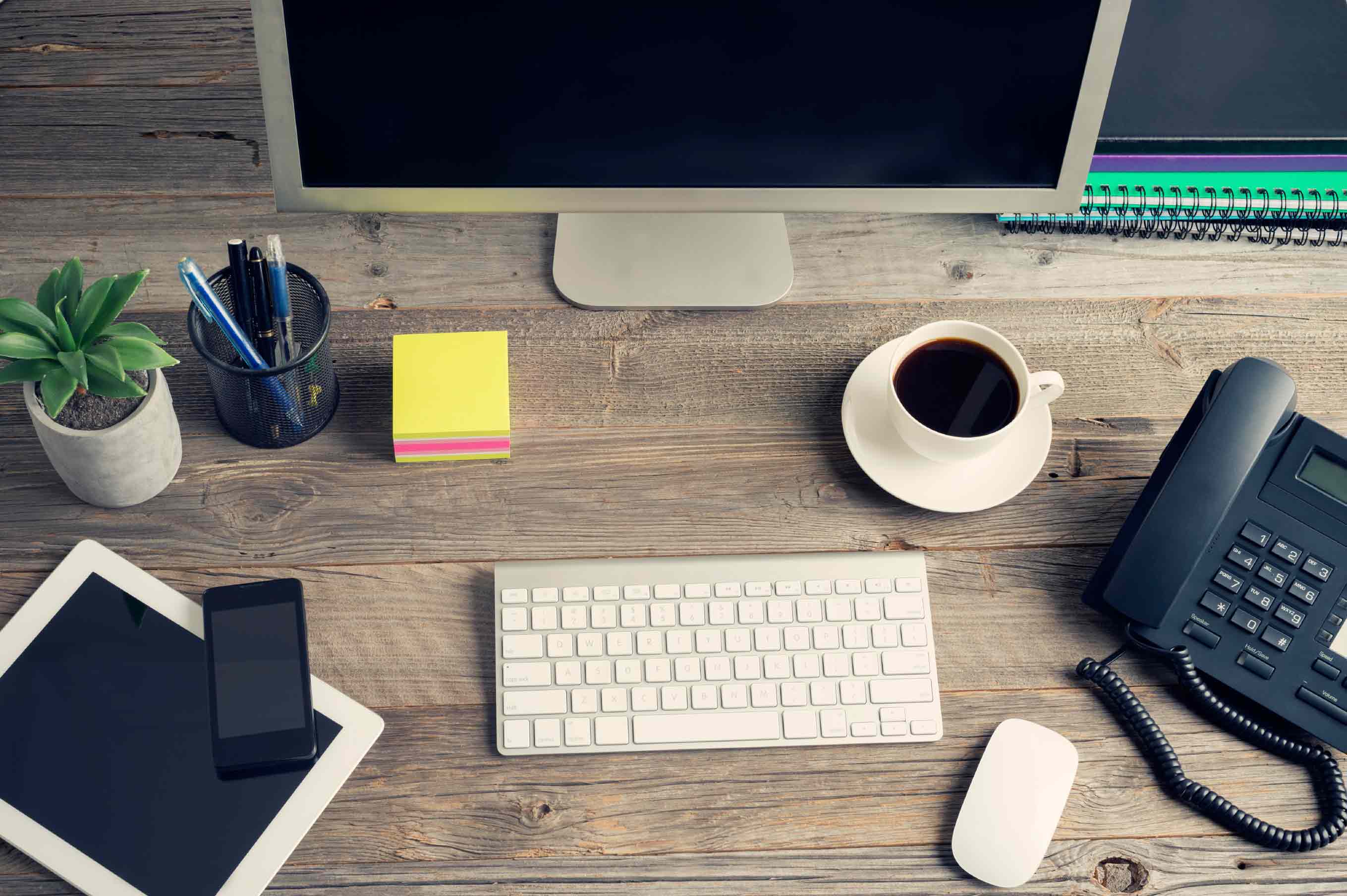 computer desk with office supplies and coffee