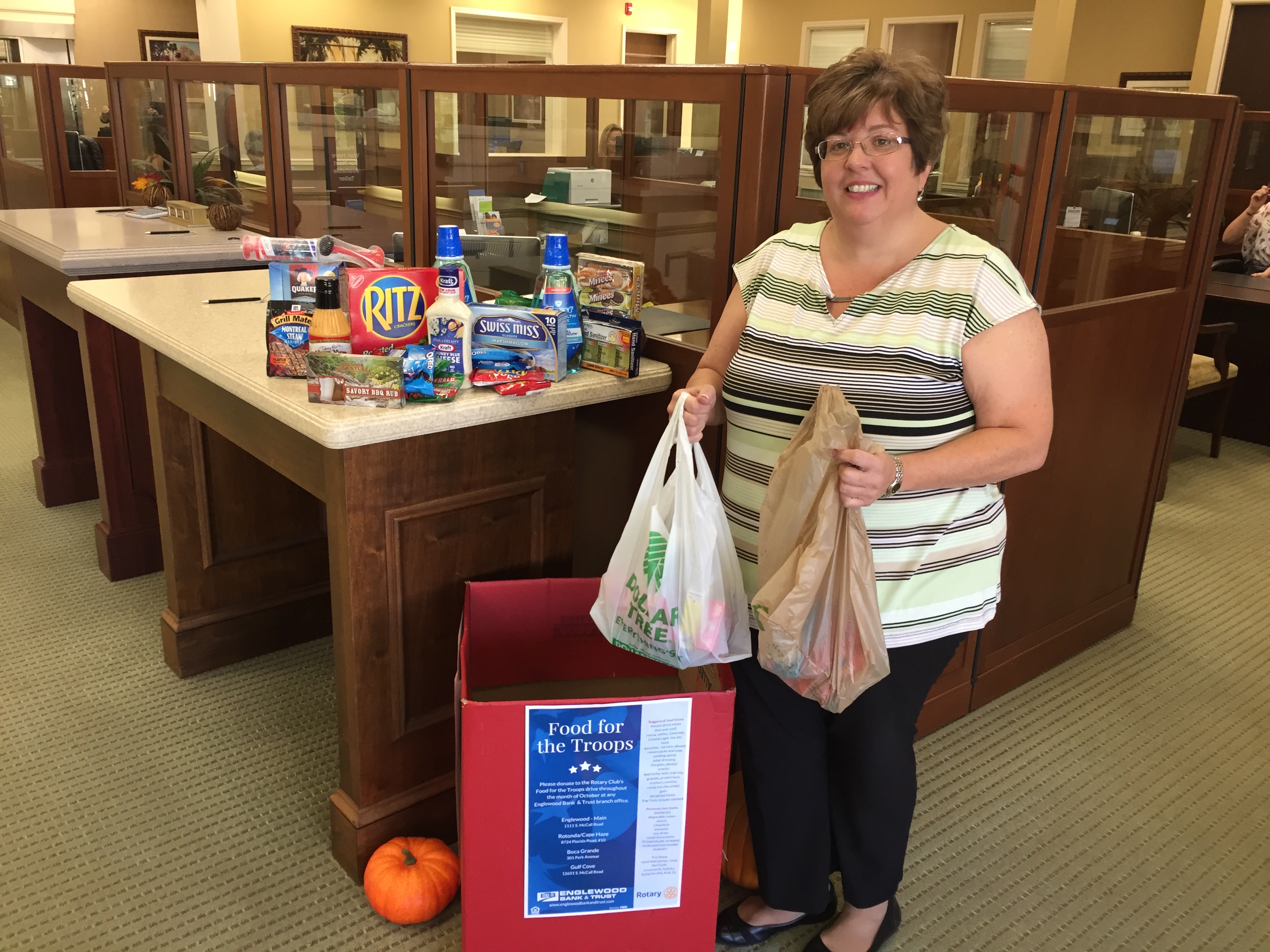 Kristina Watts, VP, Business Relationship Banker at Englewood Bank & Trust pictured with donations for Food for the Troops. People may donate during business hours at Englewood Bank & Trust through October 23.