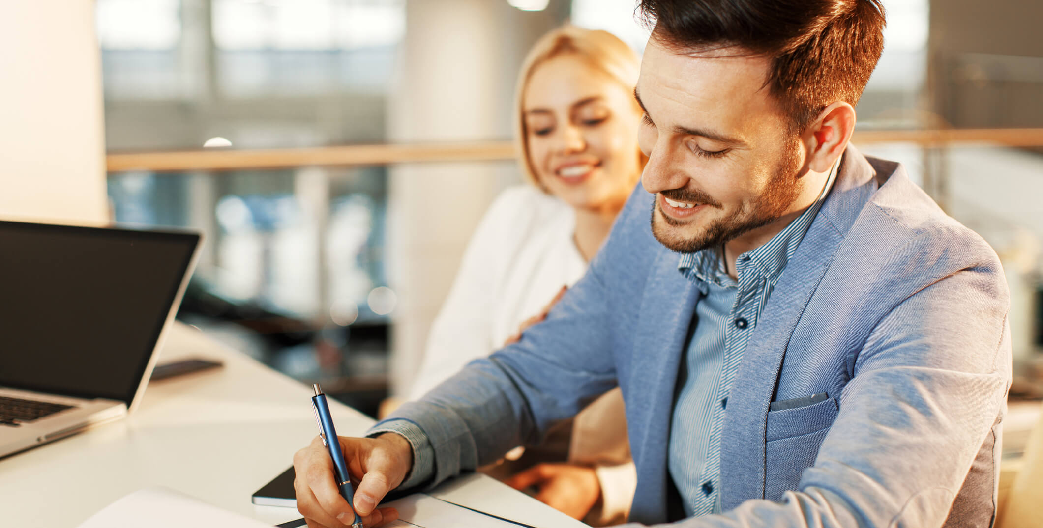 couple signing documents for commercial real estate loan