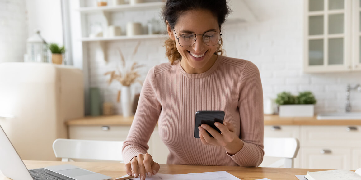 Woman smiling at her phone