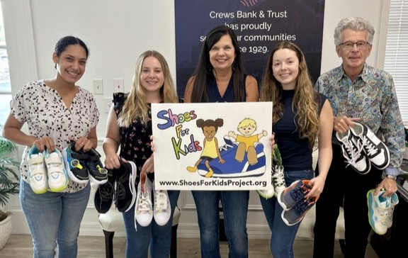 Team members with shoes for kids