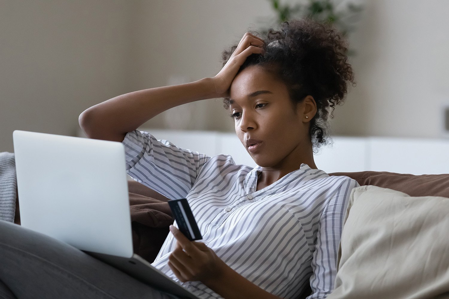 woman looking stressed at her laptop